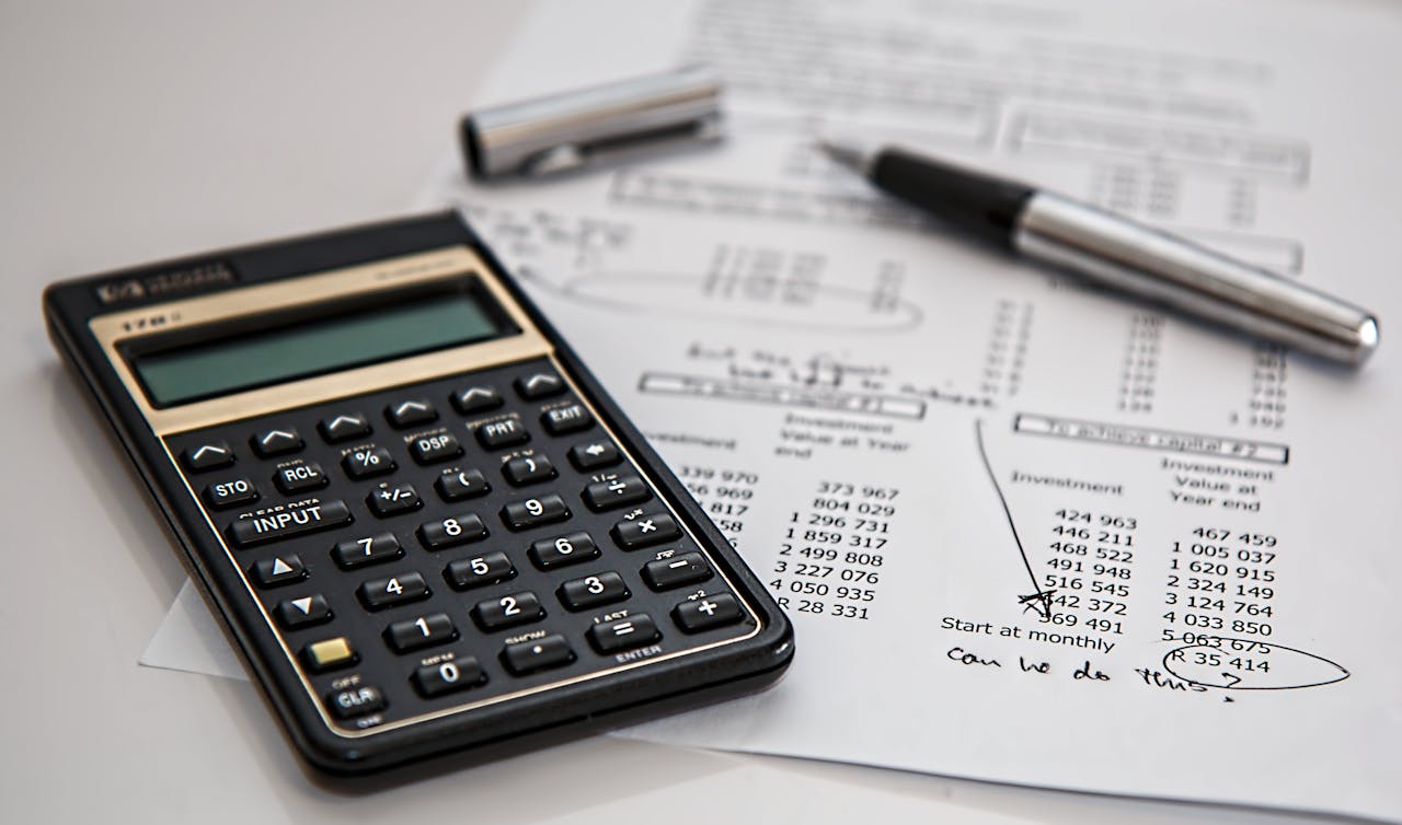 home-hero-bg Close-up of financial documents with calculator and pen, ideal for business management themes.