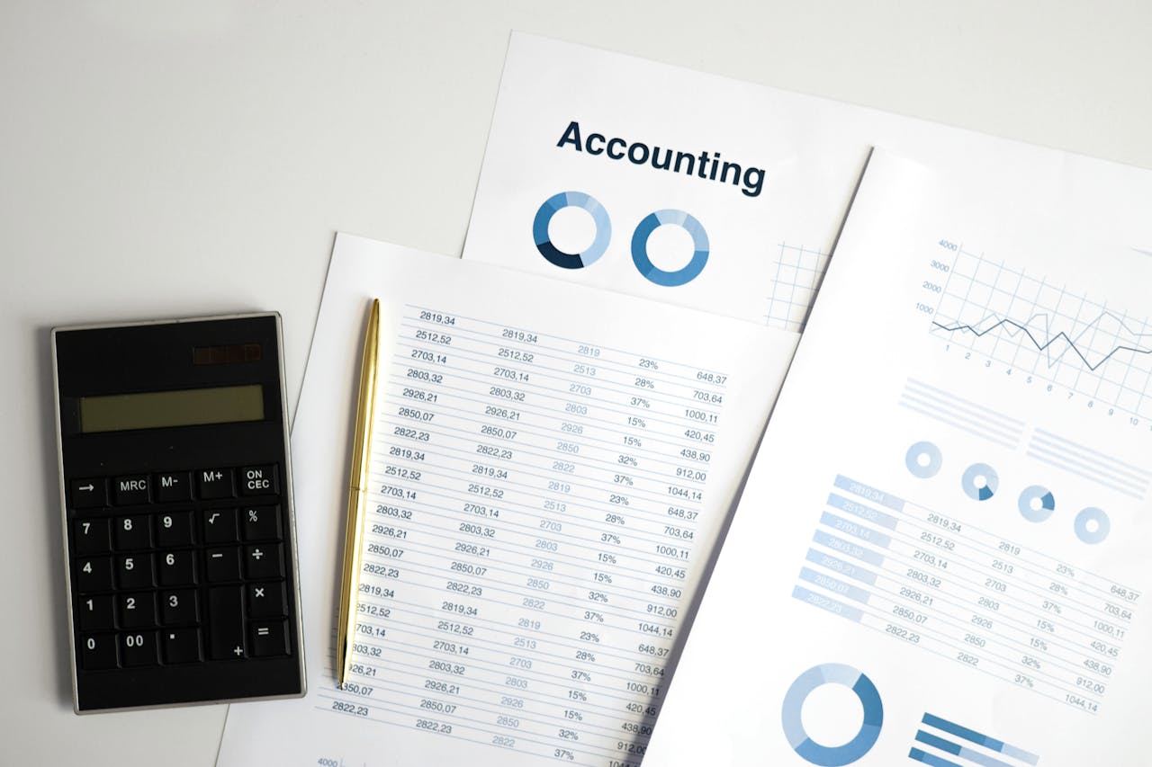 cta-bg Calculator and accounting documents with charts on a workspace.