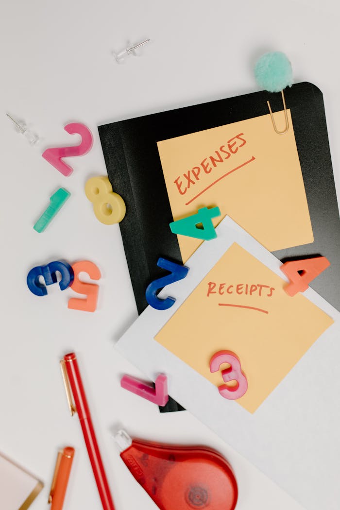 story-img Flat lay of colorful office supplies and sticky notes labeled 'Expenses' and 'Receipts'.