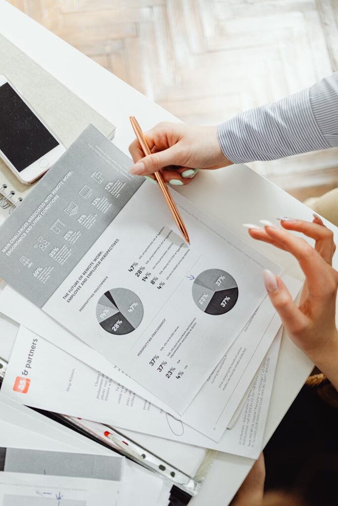pexels photo 7681097 Close-up of businesswoman analyzing financial reports using pie charts in an office setting.