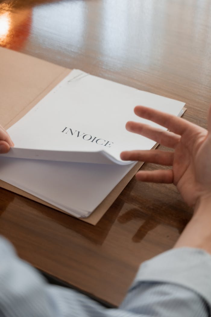 services-01 Businessman's hand going through invoices on a table, conveying business management concept.
